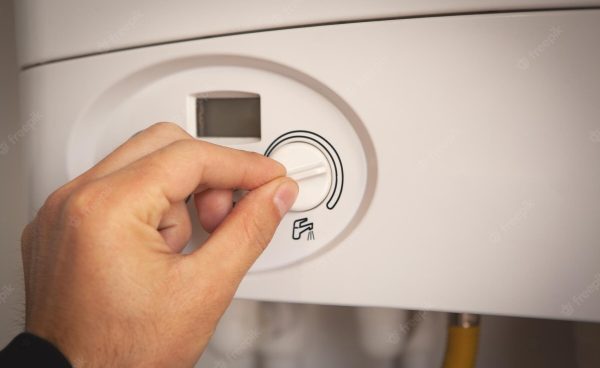 worker-set-up-central-gas-heating-boiler-home_391052-7747